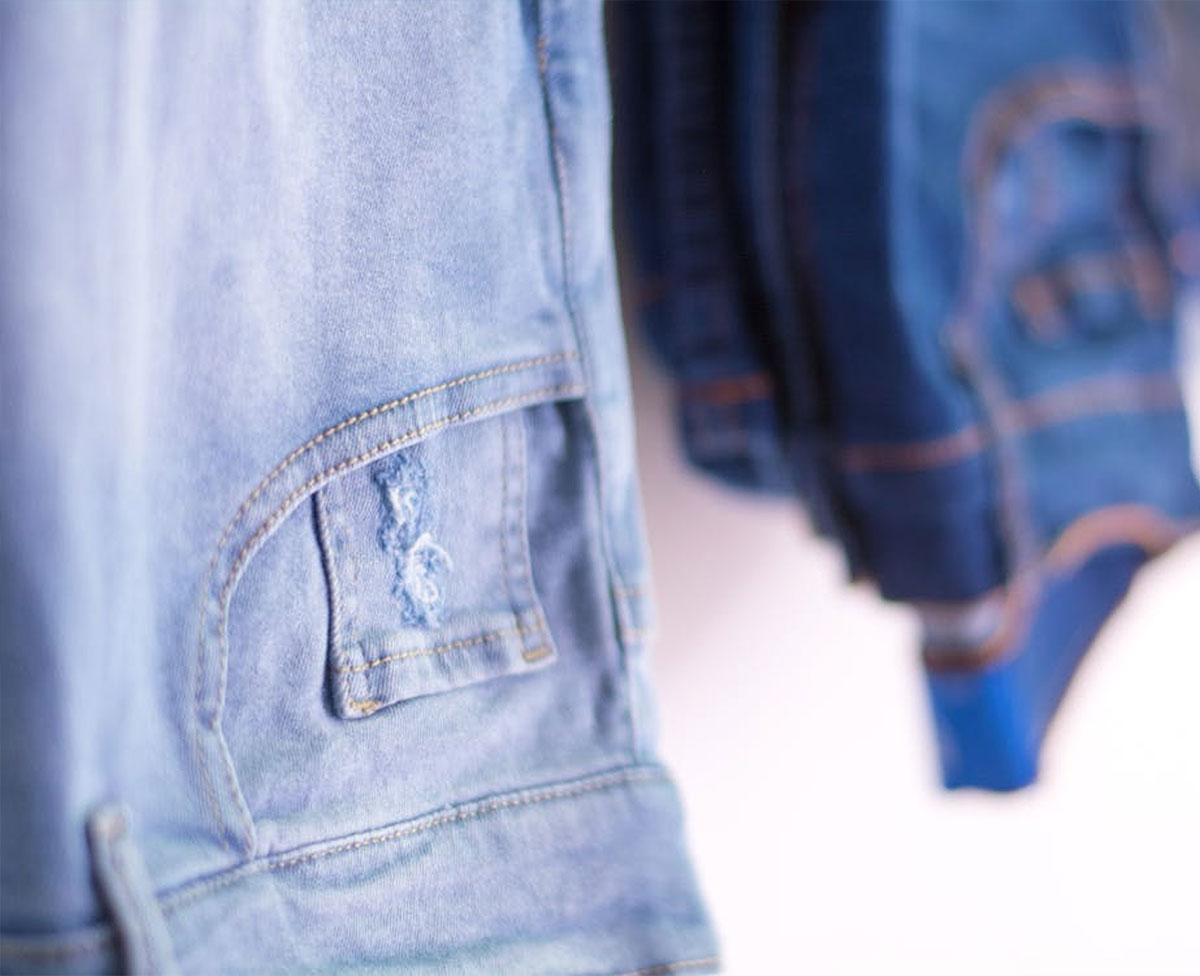 Quality control specialist inspecting fabric texture and stitching in a textile factory